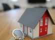 House keys and a model home illustrating homeownership planning.