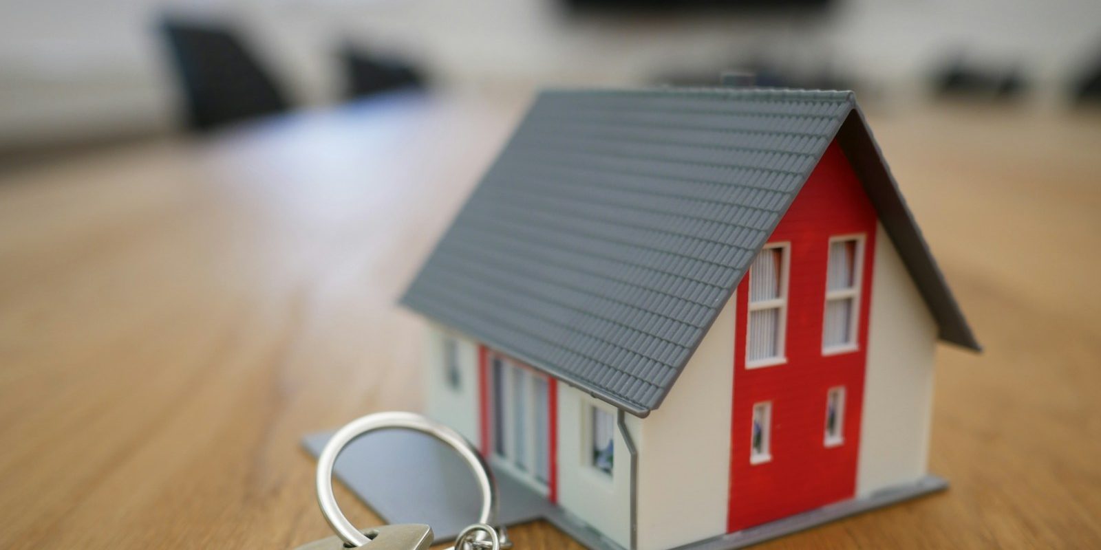 House keys and a model home illustrating homeownership planning.