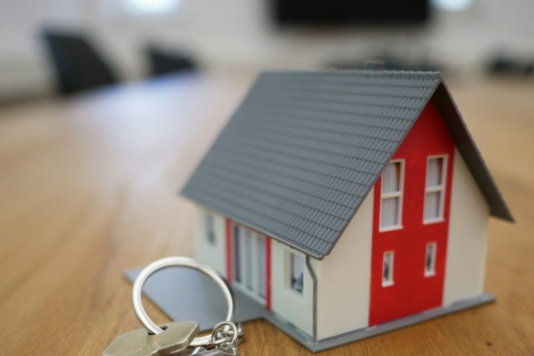 House keys and a model home illustrating homeownership planning.